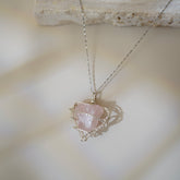 Heartsigh raw rose quartz necklace wire wrapped in silver.